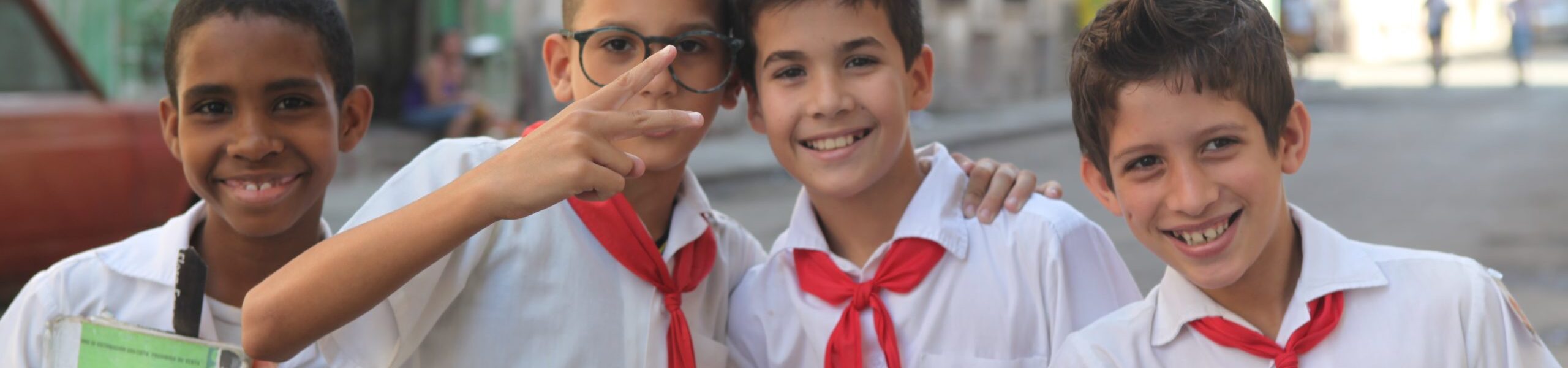 Havana, Cuba-February 8, 2013-School boys  mug for the camera while holding their school books.